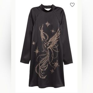 Knee-length, straight-cut dress in satin with beaded embroidery and rhinestones.